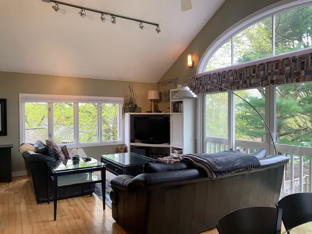 4 Potter Pond, Unit 4 Lexington, MA 02421 - Photo 5 of 15 a living room with furniture and a flat screen tv