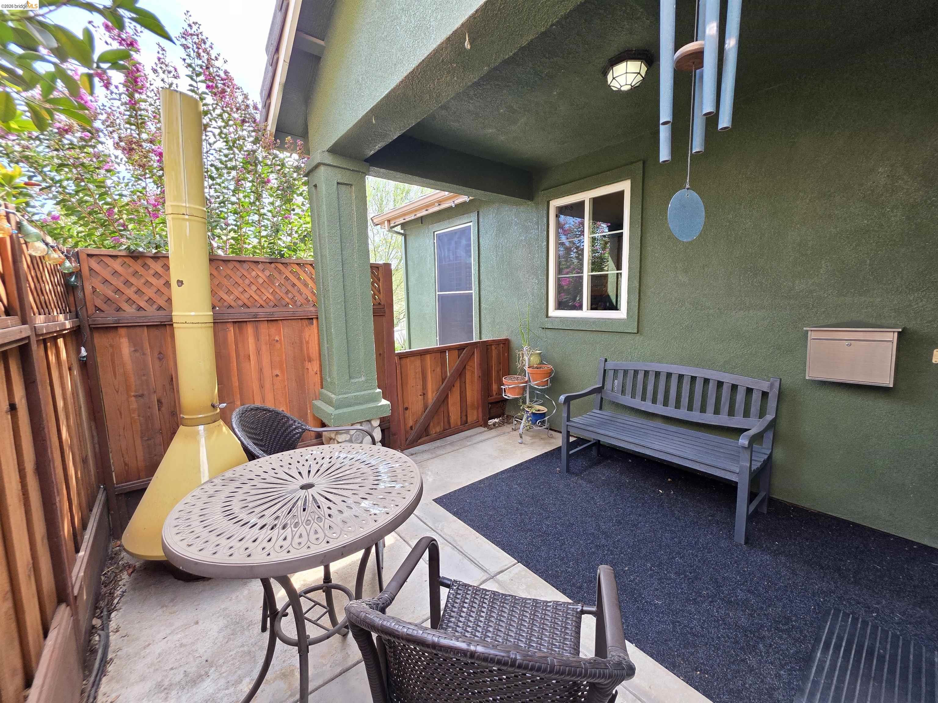 2607 Glow Road Riverbank, CA 95367 - Photo 6 of 42 Covered patio featuring a stucco exterior, window with white trim, and a built-in outdoor light fixture