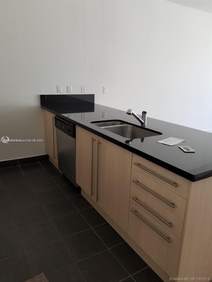 1111 Southwest 1st Avenue, Unit 1724N Miami, FL 33130 - Photo 12 of 17 a kitchen with a sink and cabinets