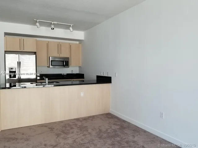 a kitchen with granite countertop a sink and a stove top oven