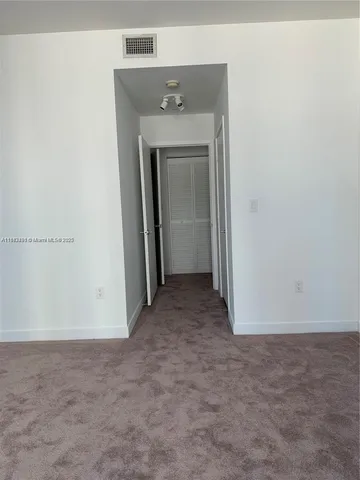 a view of a hallway with closet