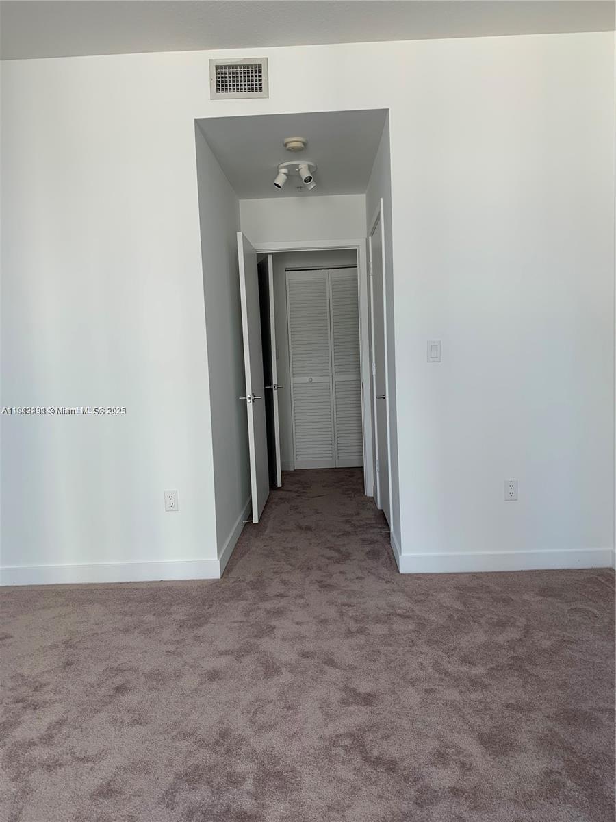 1111 Southwest 1st Avenue, Unit 1724N Miami, FL 33130 - Photo 9 of 17 a view of a hallway with closet