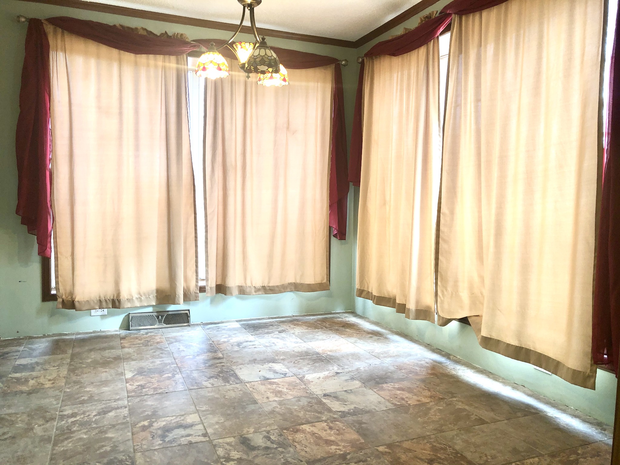 218 Watson Road Bumpus Mills, TN 37028 - Photo 11 of 23 an empty room with a windows and a chandelier