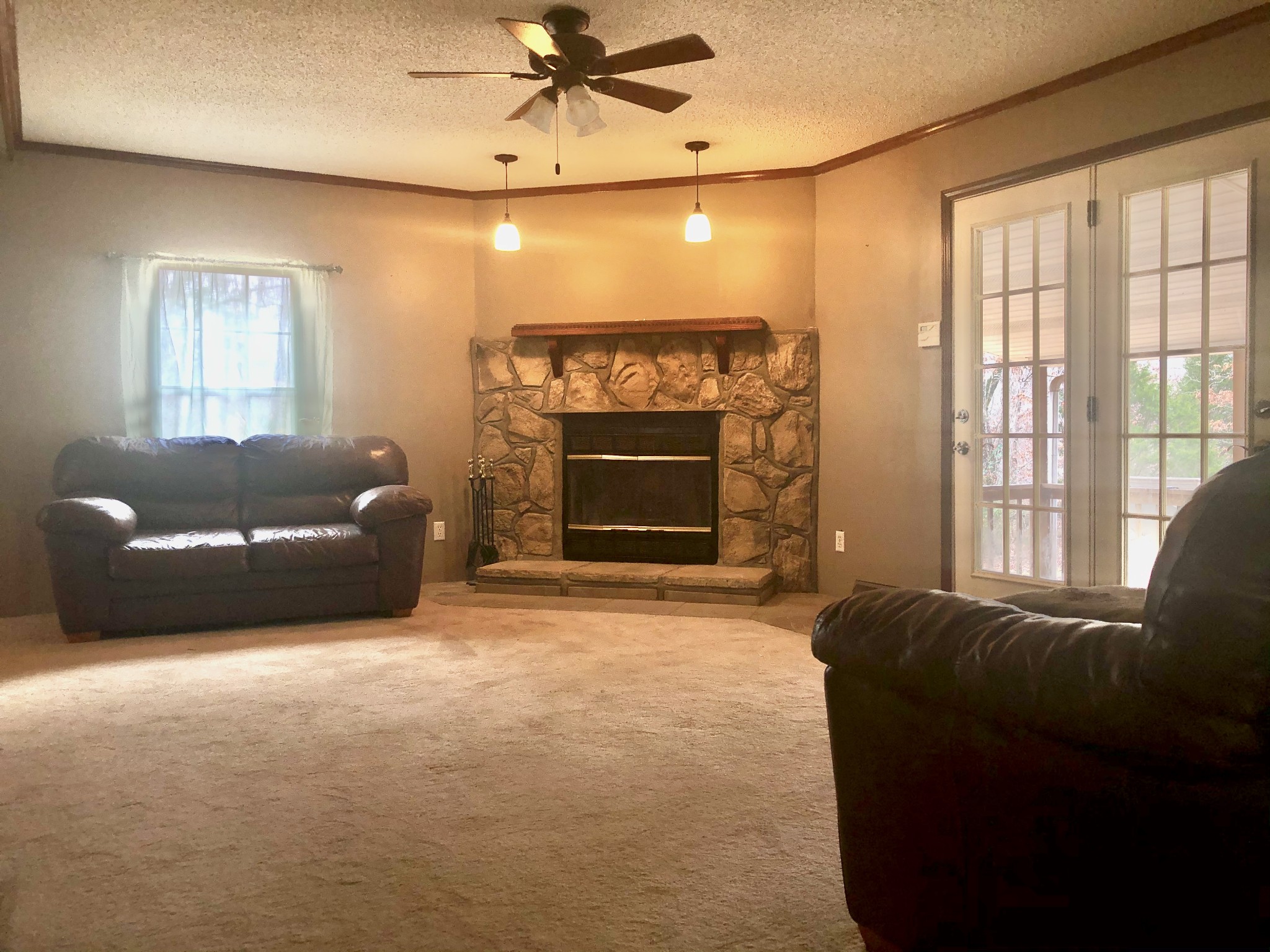 218 Watson Road Bumpus Mills, TN 37028 - Photo 12 of 23 a living room with furniture a window and a fireplace