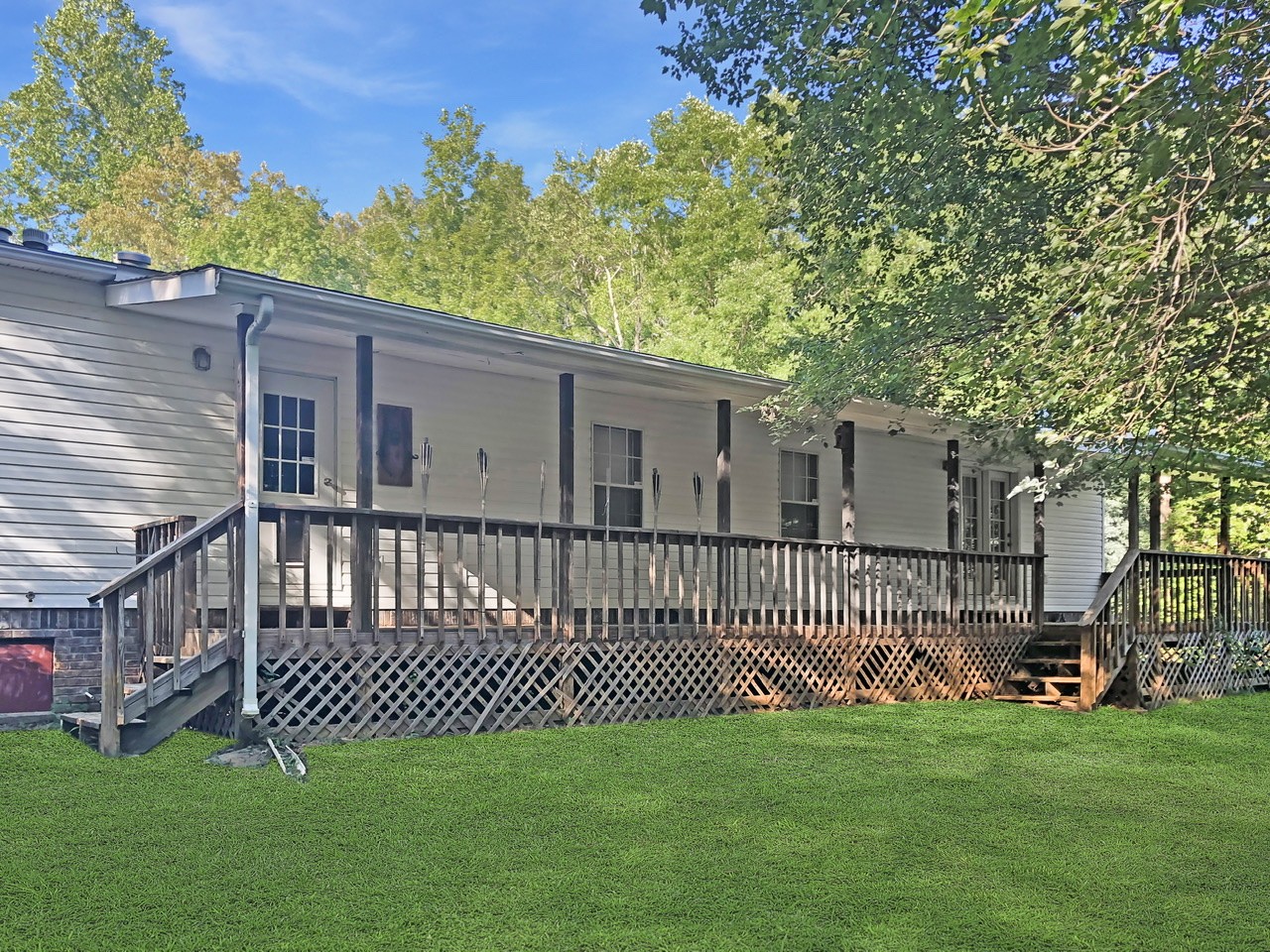 218 Watson Road Bumpus Mills, TN 37028 - Photo 4 of 23 a front view of a house with a garden