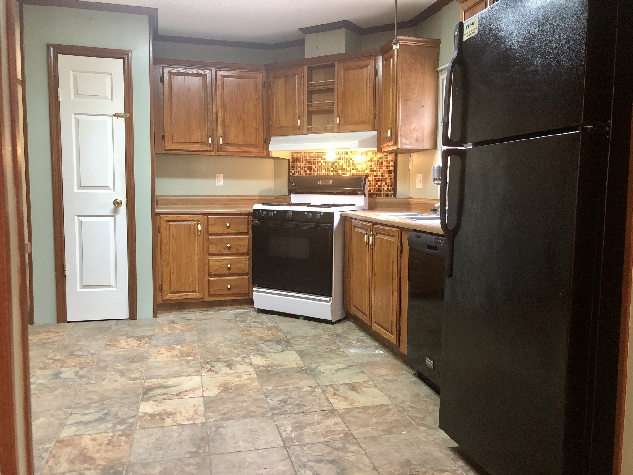 218 Watson Road Bumpus Mills, TN 37028 - Photo 8 of 23 a kitchen with granite countertop a refrigerator and a stove