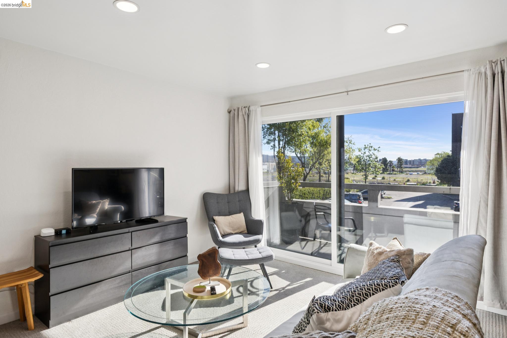 5 Embarcadero, Unit 129 Oakland, CA 94607 - Photo 13 of 32 Living area with carpet flooring and recessed lighting