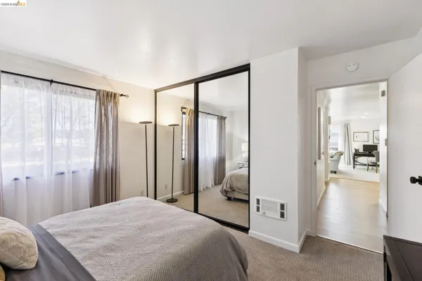 a bedroom with a balcony a bed and a mirror