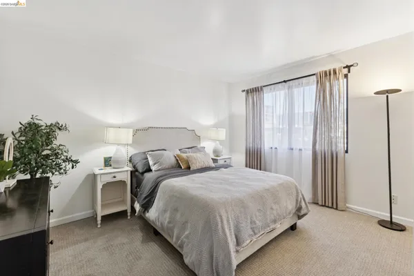 a bedroom with a bed and a potted plant
