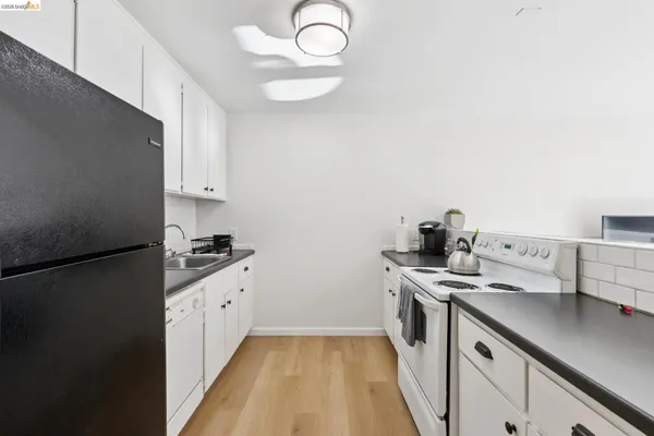 a kitchen with stainless steel appliances a sink a stove and a refrigerator