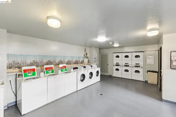 a utility room with multiple dryer and washer