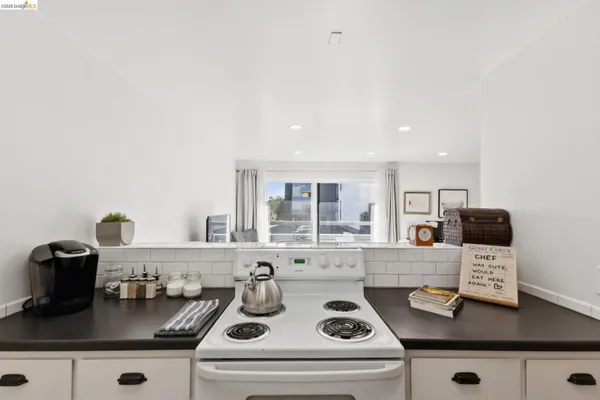 a kitchen with a stove and a white refrigerator