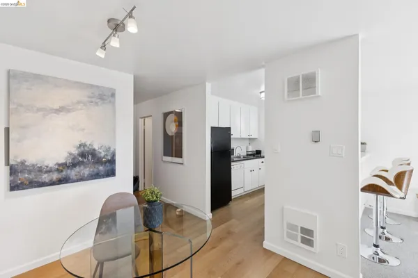 a living room with stainless steel appliances kitchen island granite countertop furniture and a fireplace