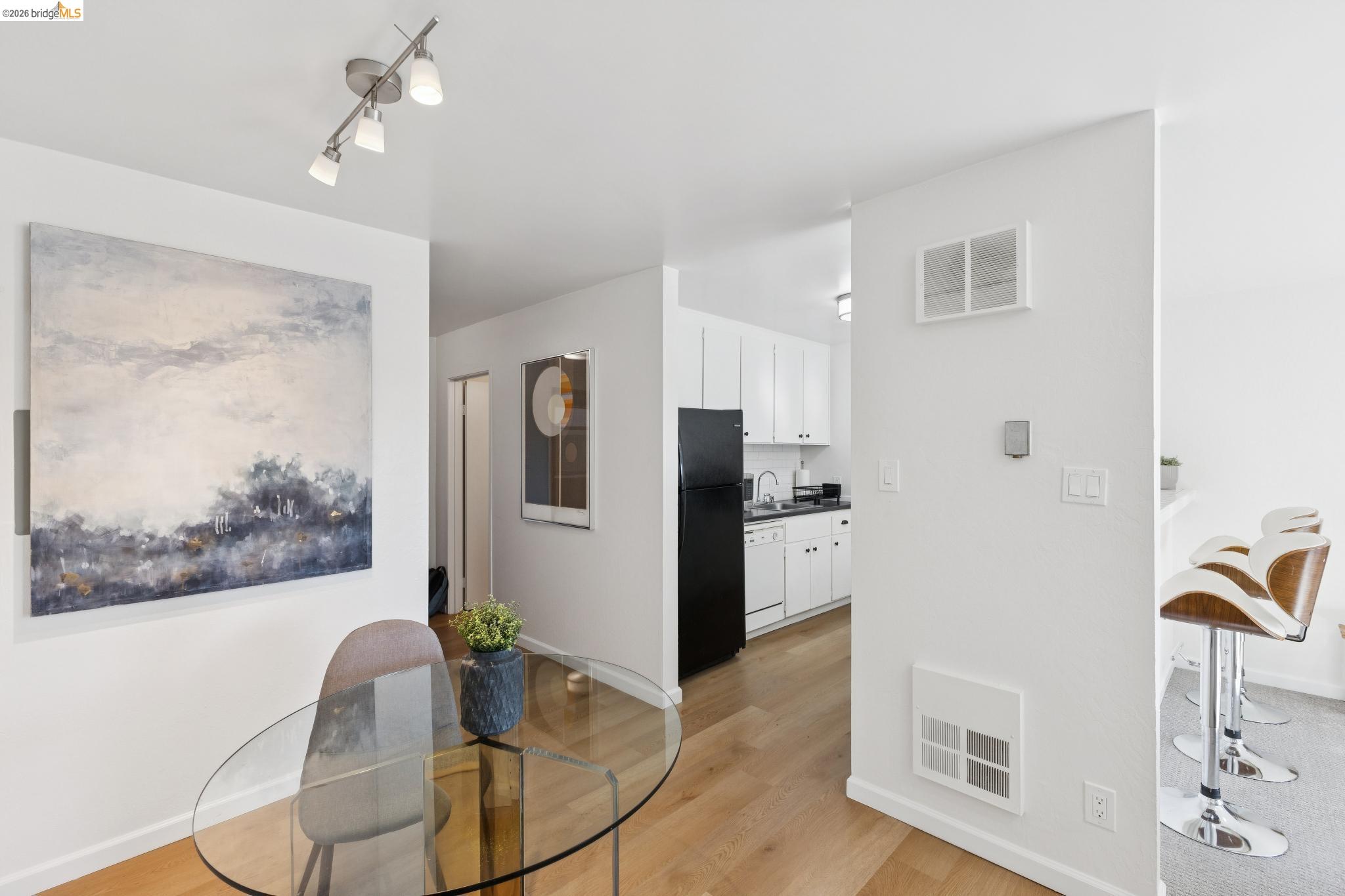 5 Embarcadero, Unit 129 Oakland, CA 94607 - Photo 5 of 32 Dining area featuring light wood-style floors and baseboards