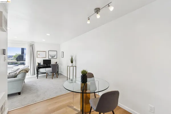 a living room with furniture and view of kitchen