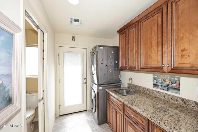 a spacious bedroom with a bed a couch and a large window