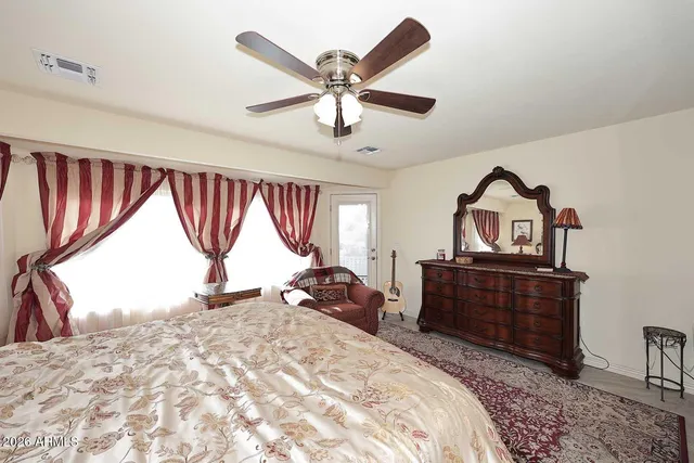 a bathroom with a granite countertop double vanity sink and a mirror