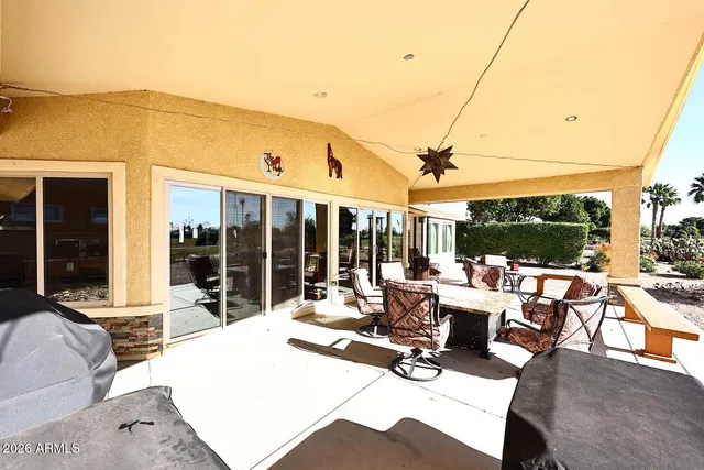 a building outdoor space with patio furniture and potted plants