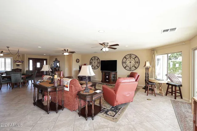 a living room with furniture a window and a clock