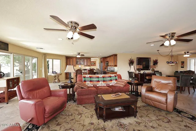 a living room with furniture ceiling fan and a rug