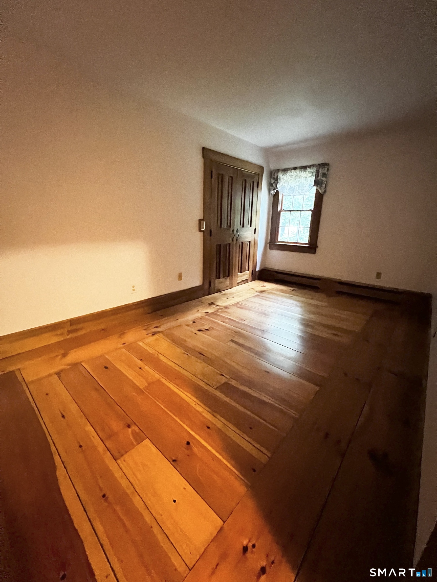 38 Clark Hill Road East Haddam, CT 06423 - Photo 33 of 35 a view of an empty room with wooden floor and a window