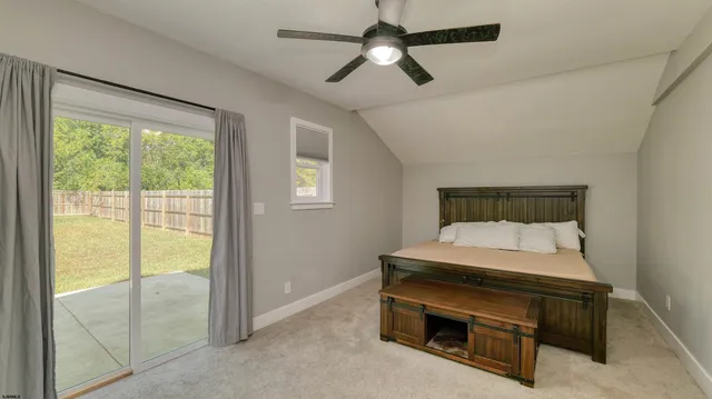 a room with furniture and a ceiling fan
