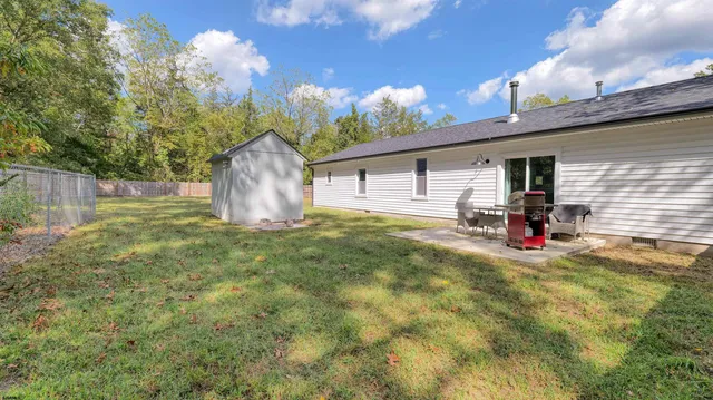 a view of a backyard with plants and outdoor seating