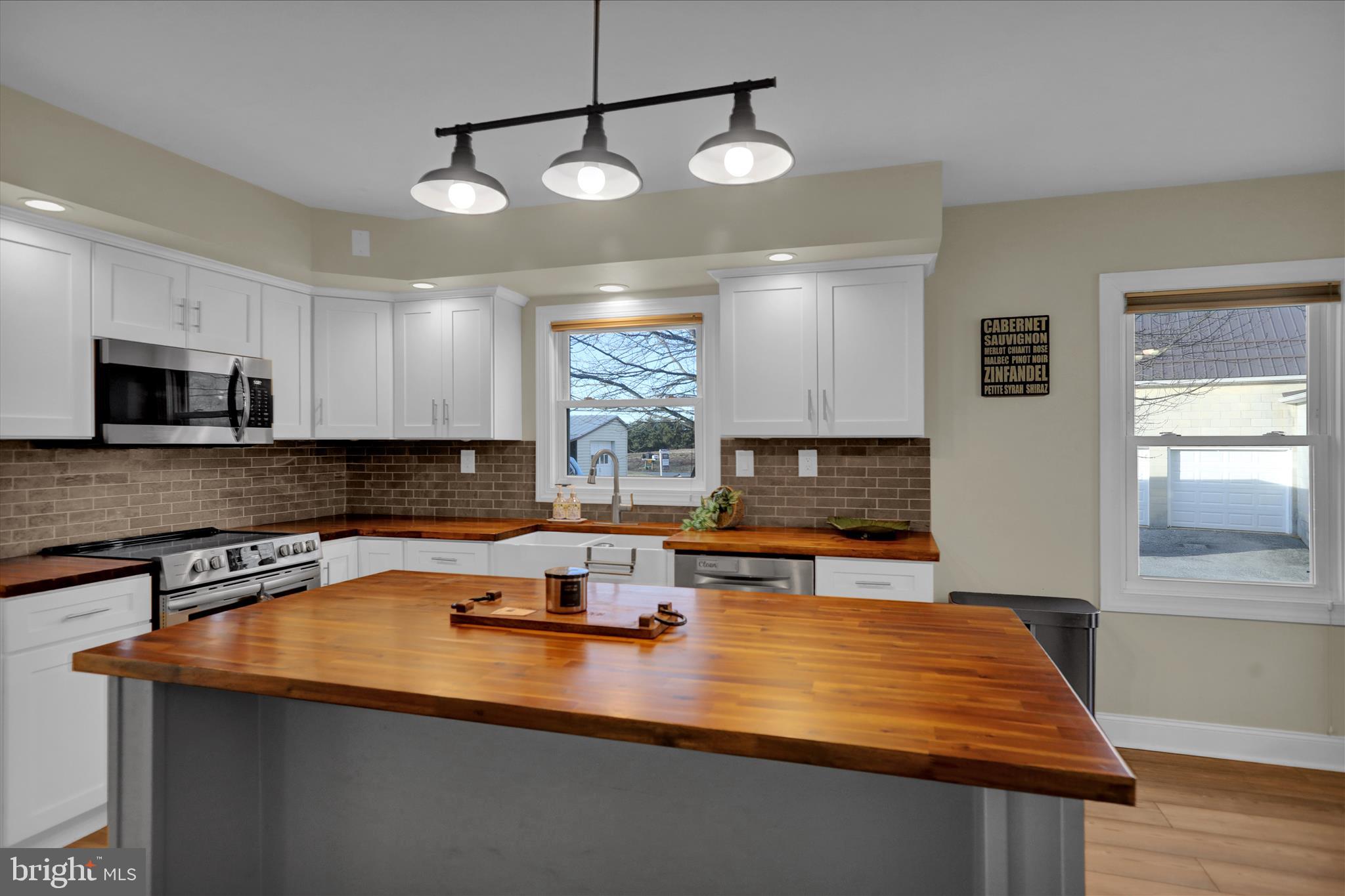303 Gates Road Hershey, PA 17033 - Photo 28 of 53 a kitchen with stainless steel appliances granite countertop a sink a stove and microwave