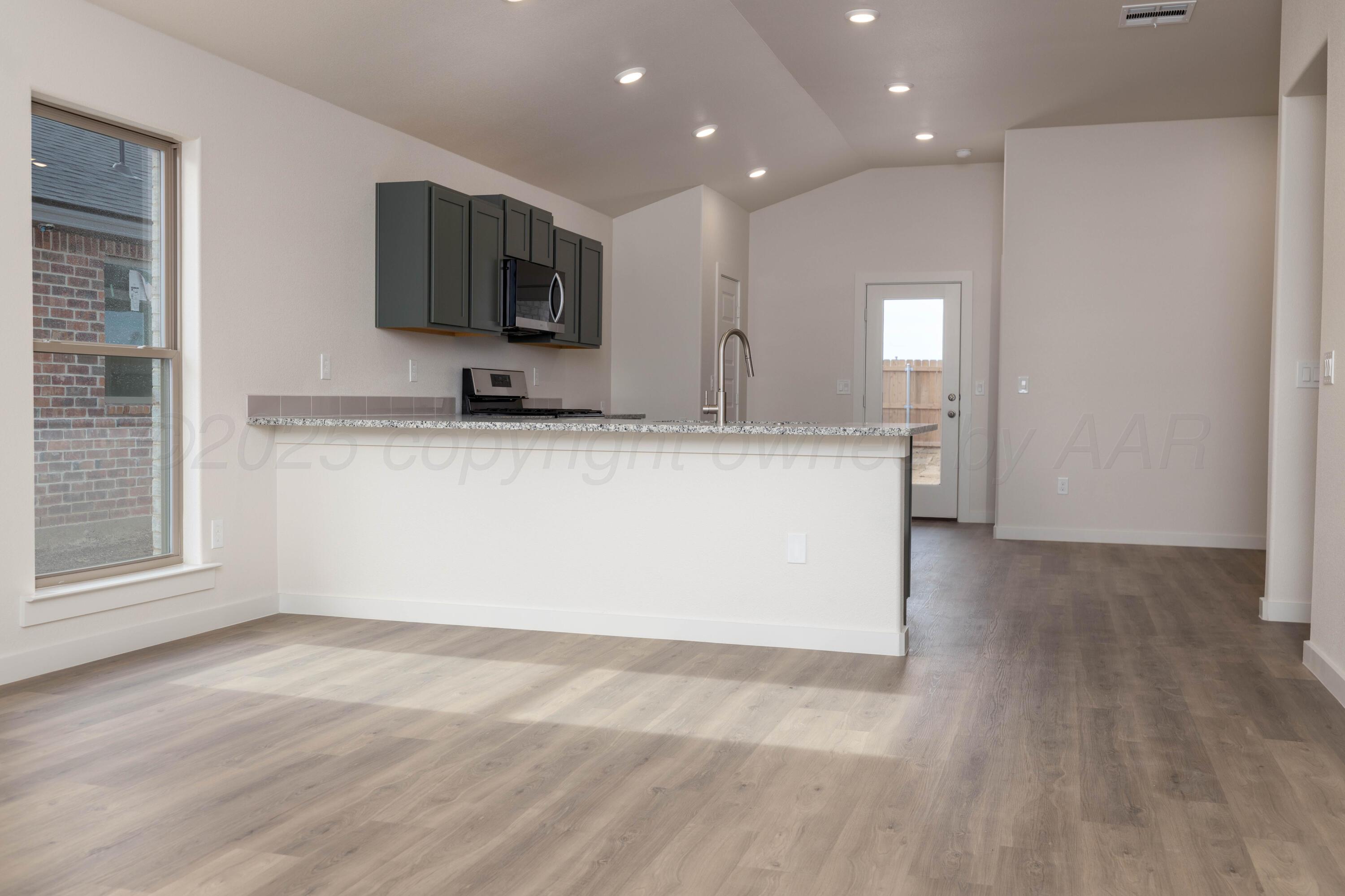 3106 Flycatcher Road Amarillo, TX 79124 - Photo 4 of 9 a view of a kitchen with a sink and a microwave