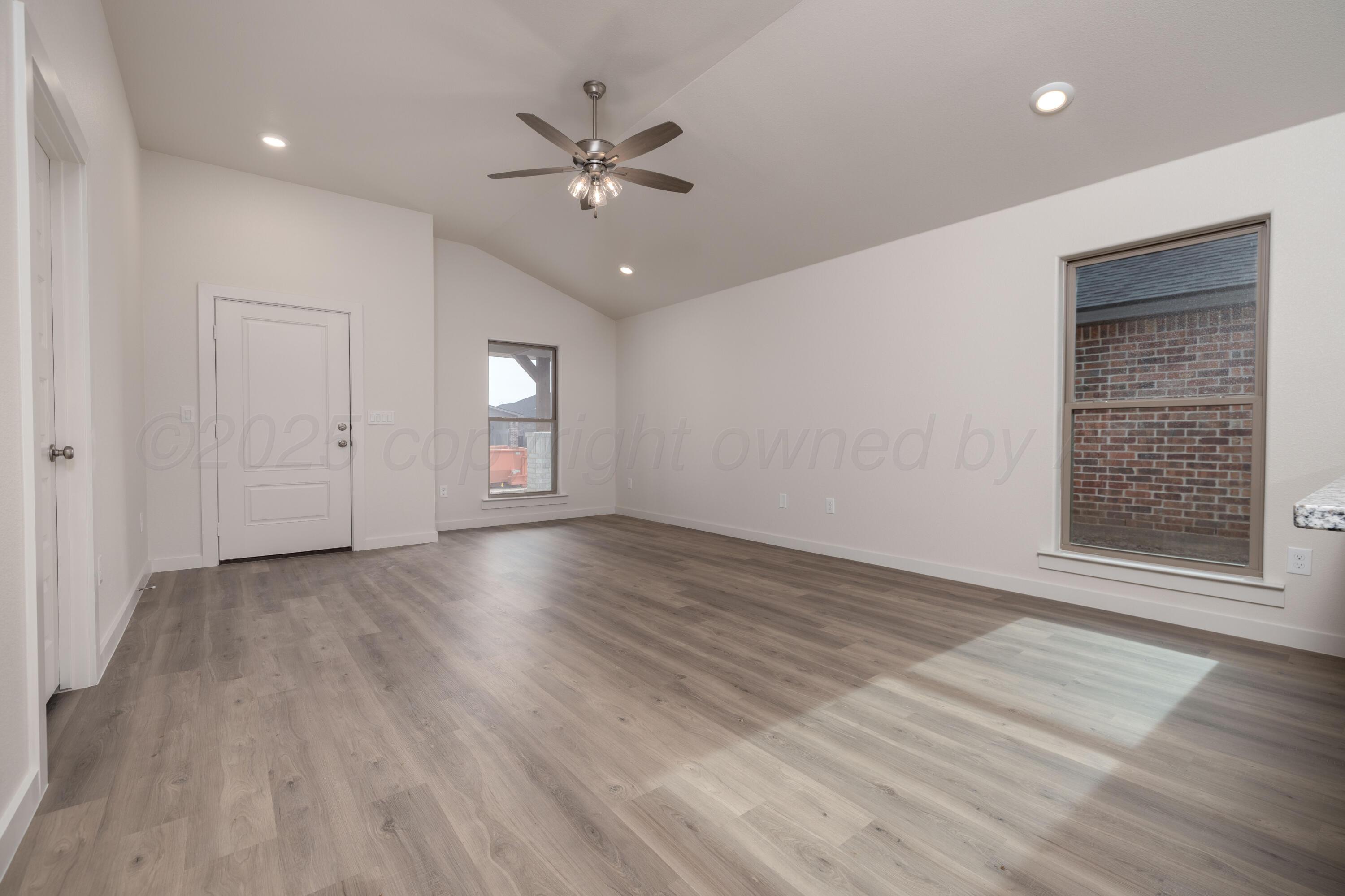 3106 Flycatcher Road Amarillo, TX 79124 - Photo 5 of 9 wooden floor in an empty room with a window