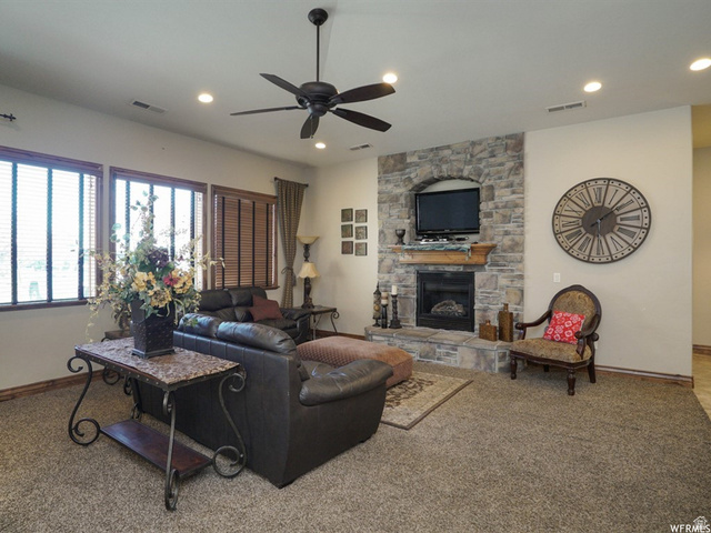905 South Main Street, Unit G Layton, UT 84041 - Photo 30 of 36 Living area with a stone fireplace, carpet floors, ceiling fan, and recessed lighting
