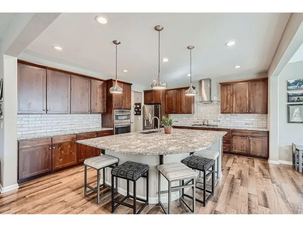 a kitchen with stainless steel appliances kitchen island granite countertop a sink and cabinets