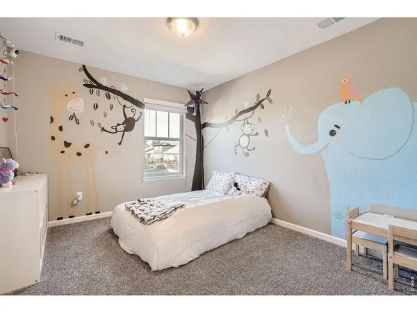 a bedroom with a bed and a chair