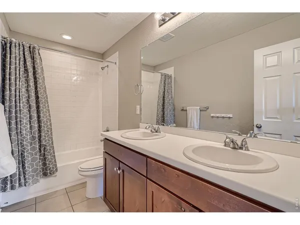 a bathroom with a sink toilet a mirror and shower