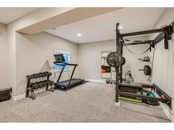 a room with gym equipment and a mirror