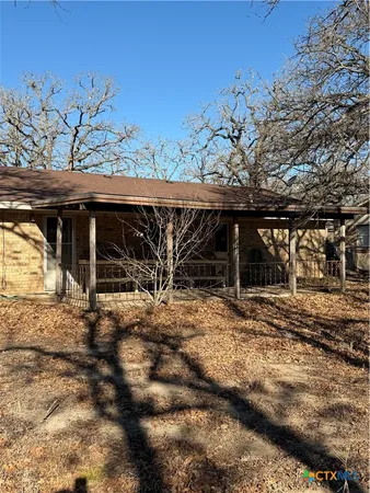 a view of a house with a large tree