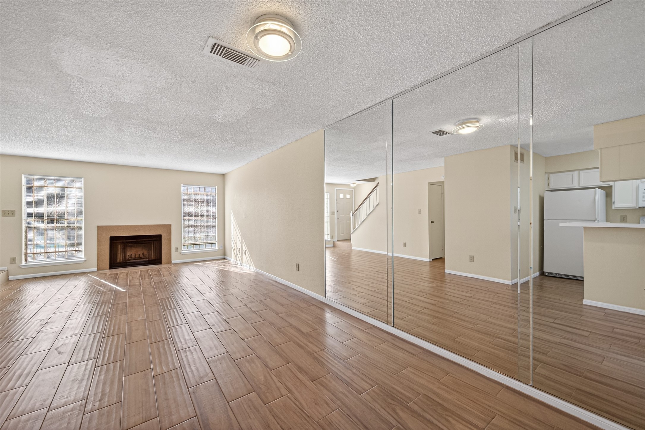 3100 Jeanetta Street, Unit 1004 Houston, TX 77063 - Photo 16 of 46 an empty room with wooden floor and fireplace
