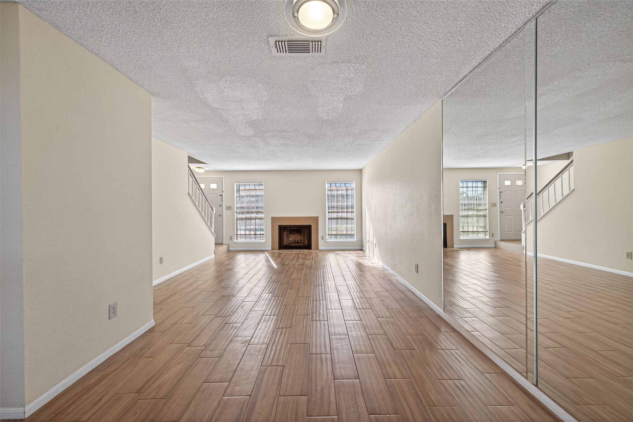3100 Jeanetta Street, Unit 1004 Houston, TX 77063 - Photo 17 of 46 a view of a livingroom with wooden floor and a ceiling fan