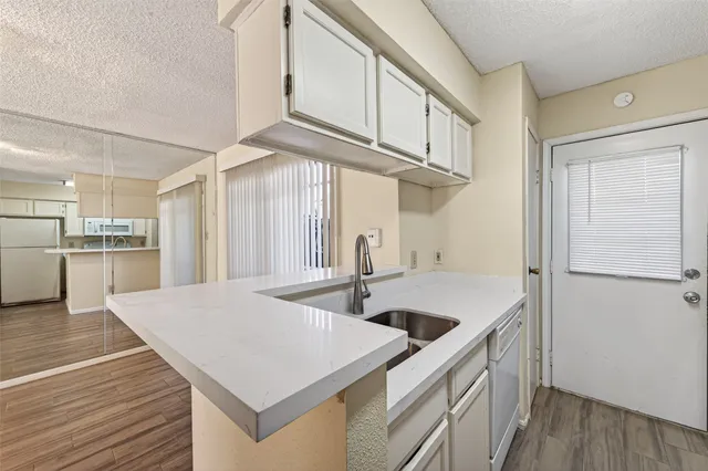 a kitchen that has a sink and a stove