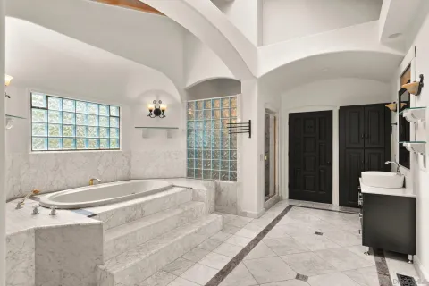 a bathroom with a granite countertop sink a toilet and shower