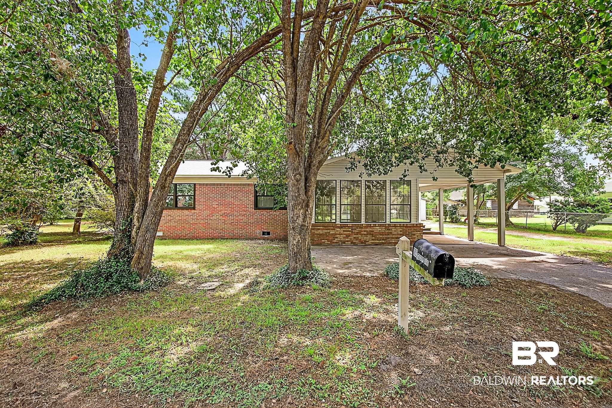 101 Terry Avenue Brewton, AL 36426 - Photo 20 of 48 View of front of property with brick siding, concrete driveway, crawl space, and a carport