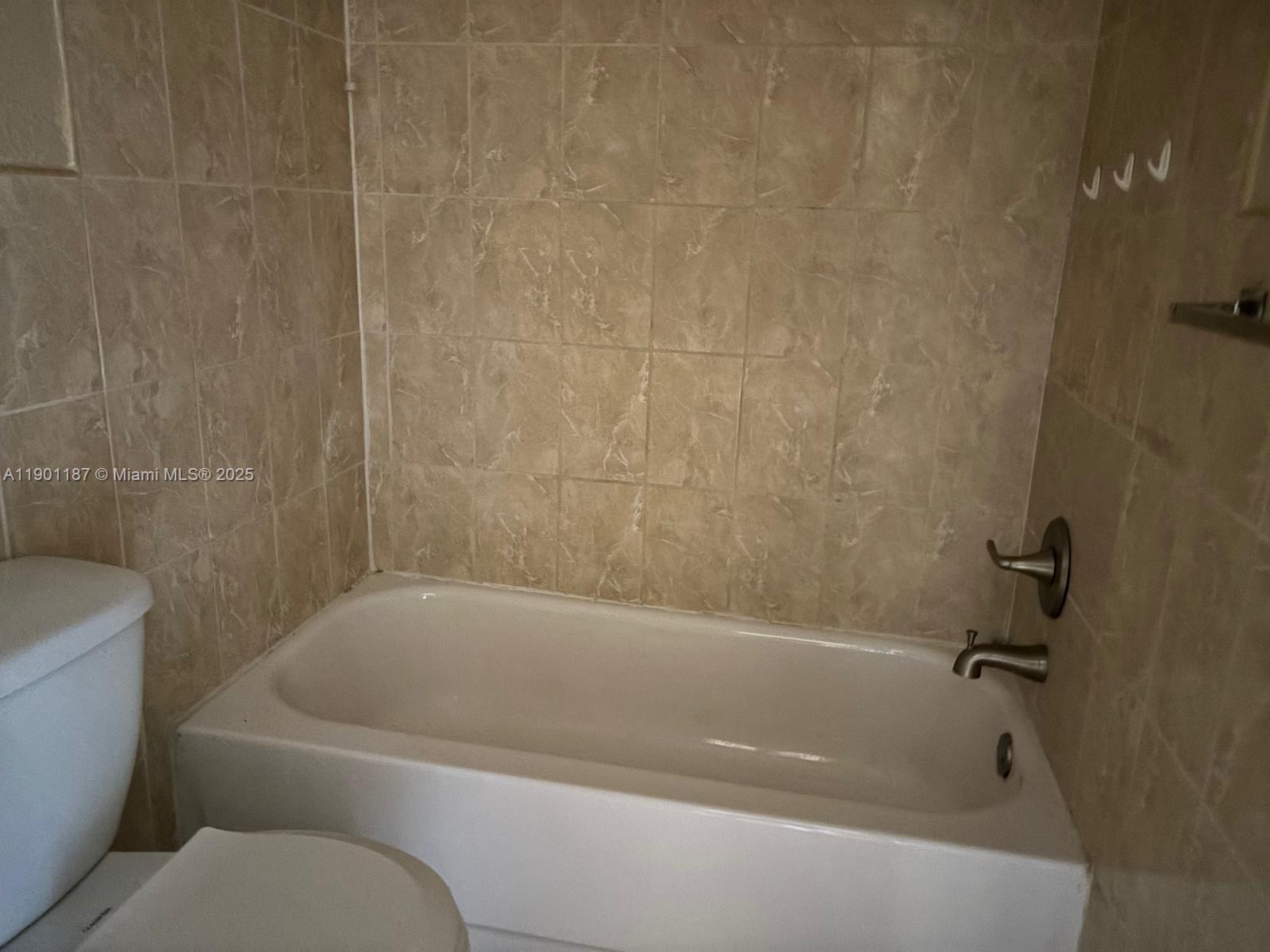 6541 Southwest 41st Court, Unit 173 Davie, FL 33314 - Photo 17 of 24 a bathroom with a bathtub and toilet