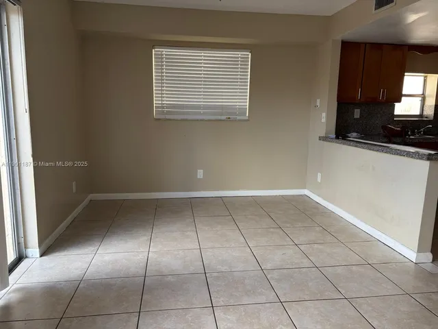 a kitchen with granite countertop a sink and a stove
