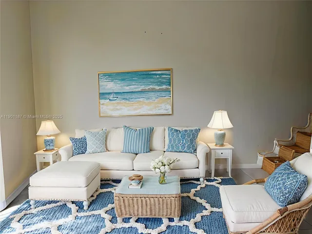 a living room with furniture and a lamp