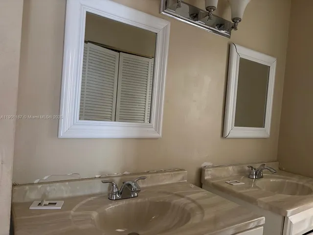 a view of a faucet cabinets