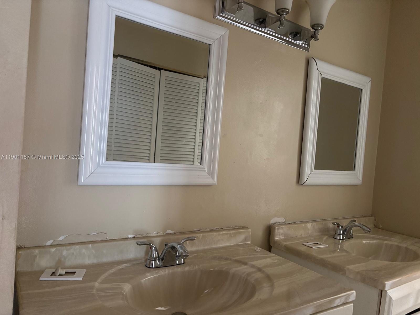 6541 Southwest 41st Court, Unit 173 Davie, FL 33314 - Photo 23 of 24 a bathroom with a sink and a mirror