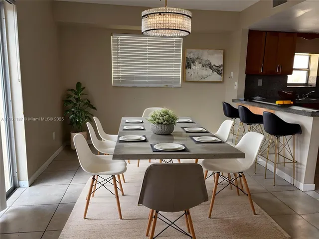 a view of a dining room with furniture and chandelier