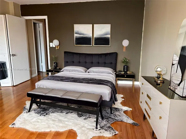 a bedroom with a bed and a mirror