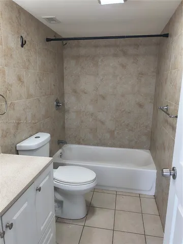 a bathroom with a toilet and a bathtub