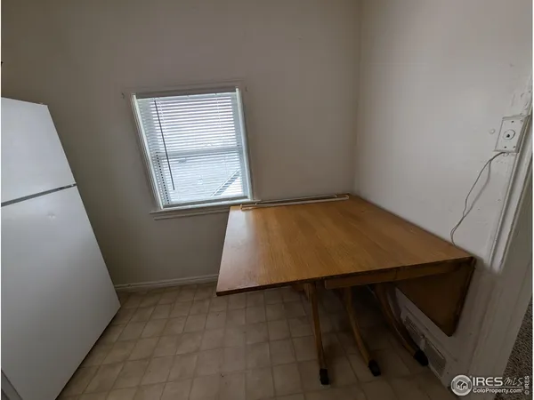 a white refrigerator freezer and a window in a room